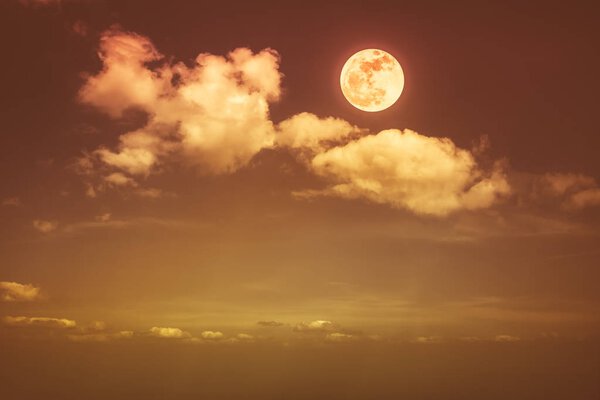 Beautiful skyscape. Landscape of night sky with clouds and bright full moon. Serenity nature background, outdoor at nighttime with moonlight. Sepia tone. The moon taken with my own camera.