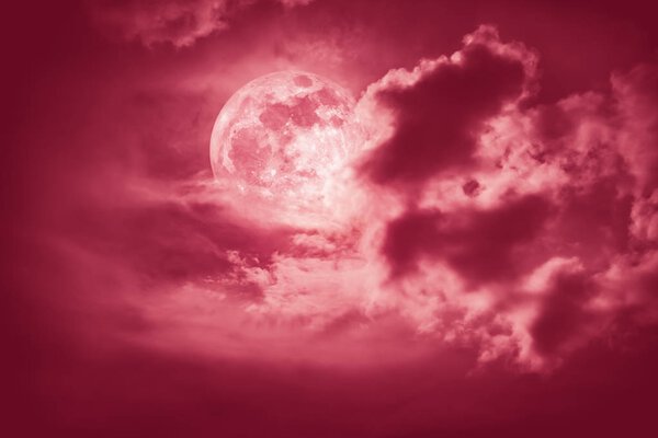 Attractive photo of cloudscape at nighttime. Night landscape of red sky with bright full moon behind clouds, serenity nature background. The moon taken with my own camera.