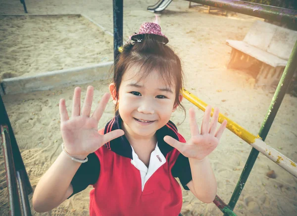 Adorable asian girl having fun at children plaground. Vintage tone. — Stock Photo, Image