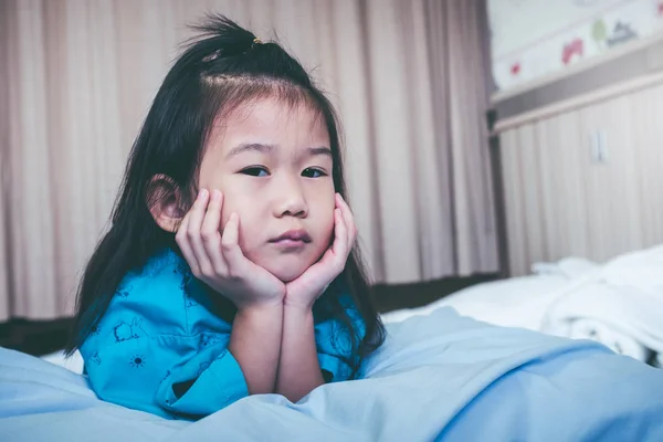 Unhappy illness asian child admitted in hospital. Vintage tone. — Stock Photo, Image