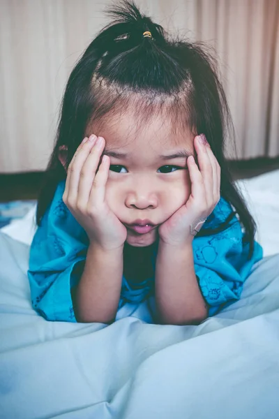 Unhappy illness asian child admitted in hospital. Vintage tone. — Stock Photo, Image