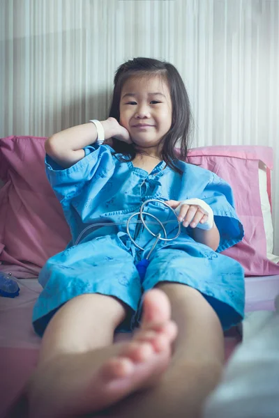 Illness asian child admitted in hospital with band-aid on hand. — Stock Photo, Image