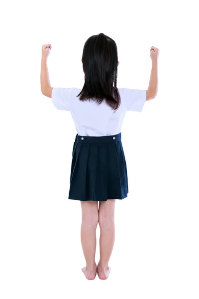 Preschool kind in uniform met haar handen omhoog bij studio. geïsoleerd op witte achtergrond. — Stockfoto