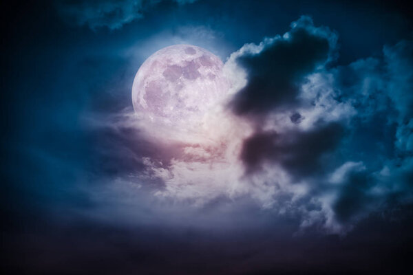 Attractive photo of cloudscape at nighttime. Night landscape of dark blue sky with bright full moon behind clouds, serenity nature background. The moon taken with my own camera.