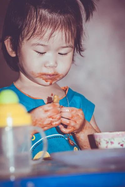 Kind isst mit fleckigem Gesicht. Do it yourself Konzept. Vintag — Stockfoto