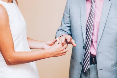 Bir çift gelin ve damadın elleri alyans değiş tokuşu yapıyor.