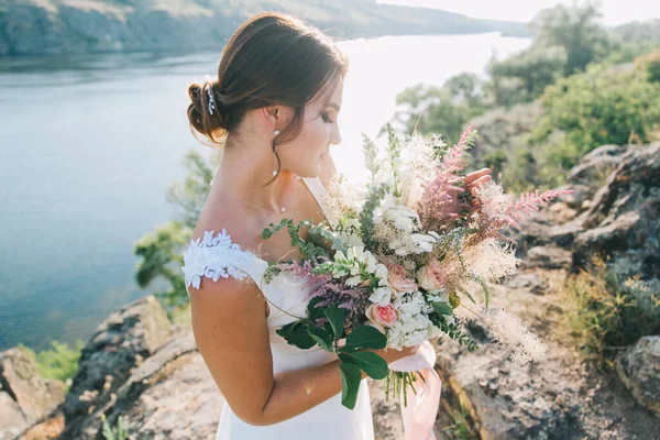 日没時に自然の中で豪華な白いウェディングドレスで花嫁 — ストック写真