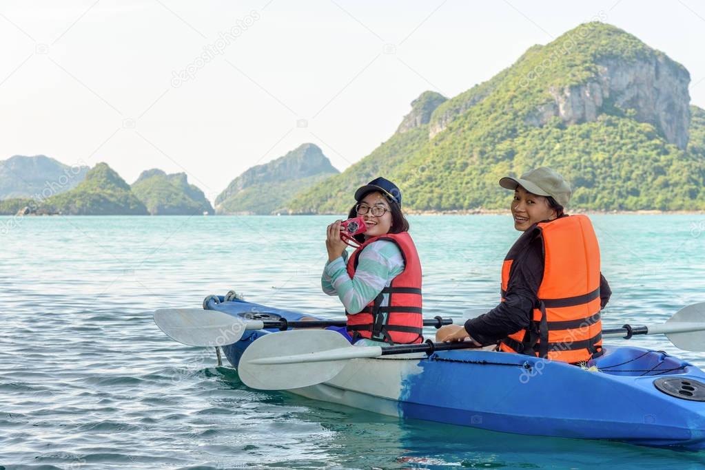Mother and daughter take pictures on kayak