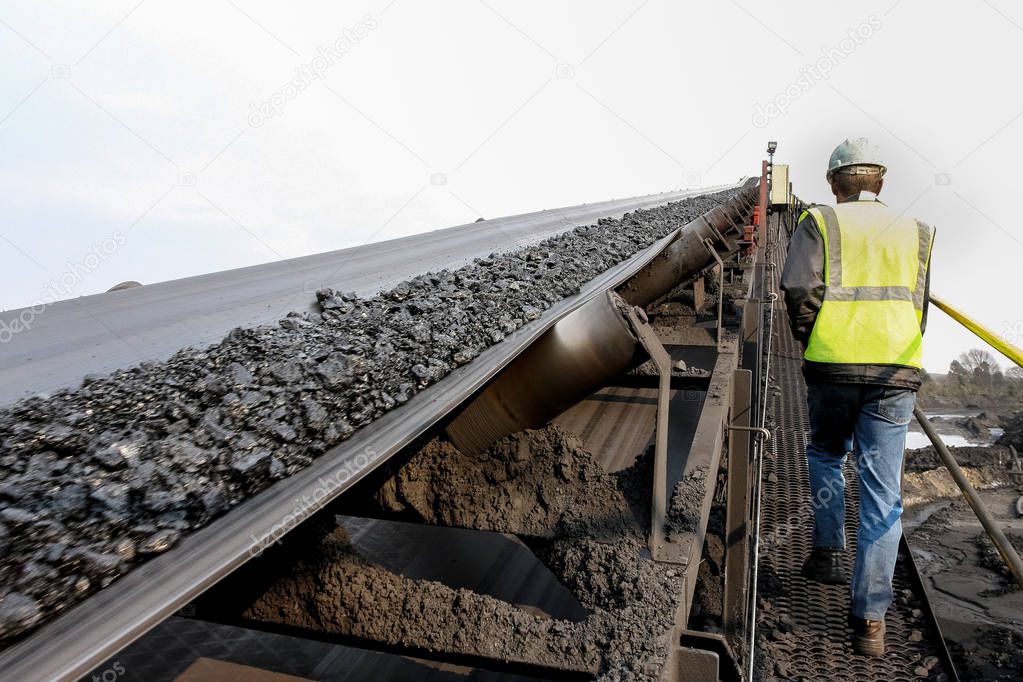 Coal moving on a conveyor belt for processing