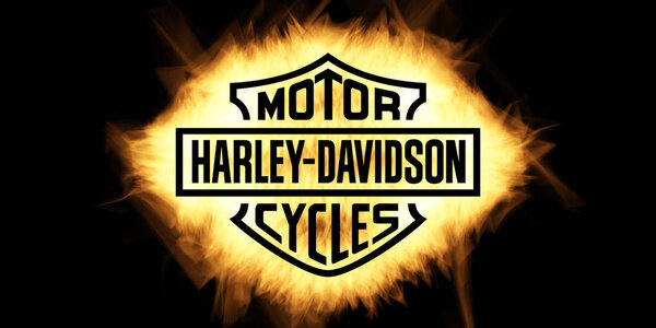 Yellow Burning Flames Effect on Harley Davidson Logo against bla