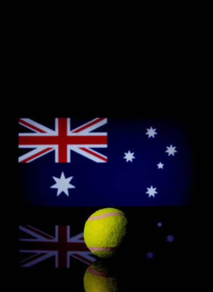 Yellow Tennis Ball on black mirror with Australian Flag in the b — Stock Photo, Image