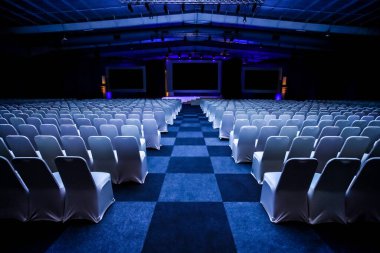 Rows of empty chairs in large Conference hall for Corporate Convention or Lecture clipart