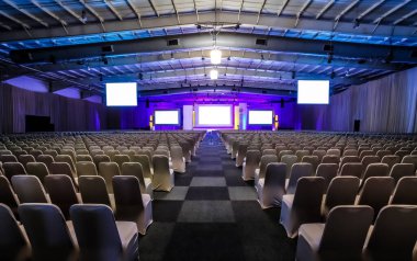 Rows of empty chairs in large Conference hall for Corporate Convention or Lecture clipart