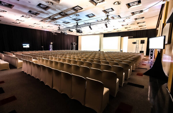 Rows of empty chairs in large Conference hall for Corporate Convention or Lecture