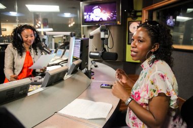 Johannesburg, South Africa - September 03, 2010: African Female Guests being interviewed on live talk radio show  clipart