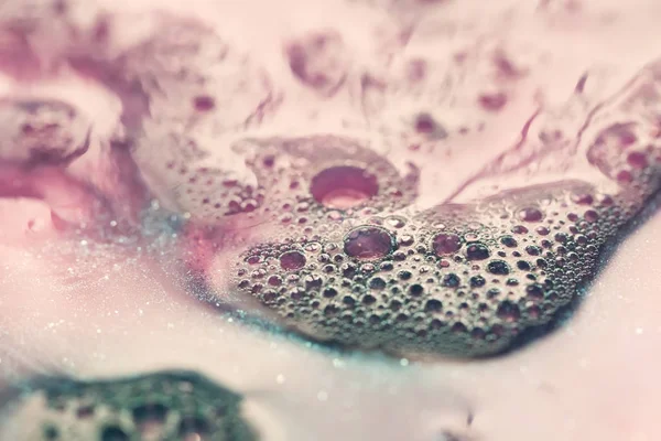 macro shot of pink soap foam texture with bubbles