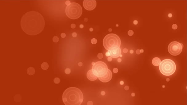 Un clip animé de particules de bokeh flottant sur un fond orange — Video