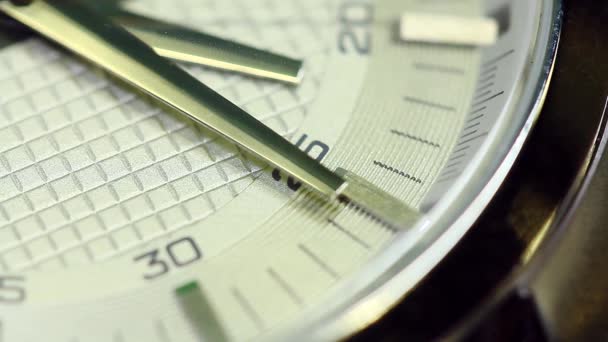 A close up macro shot of a watch face, the the seconds hand ticking past — Stock Video