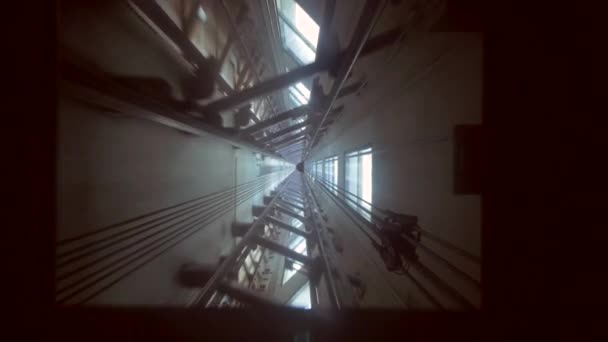 Shot through the bottom of a glass elevator whilst the elevator is descending — Stock Video