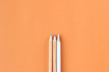 simple pencils on a paper background, top view, educational minimalism