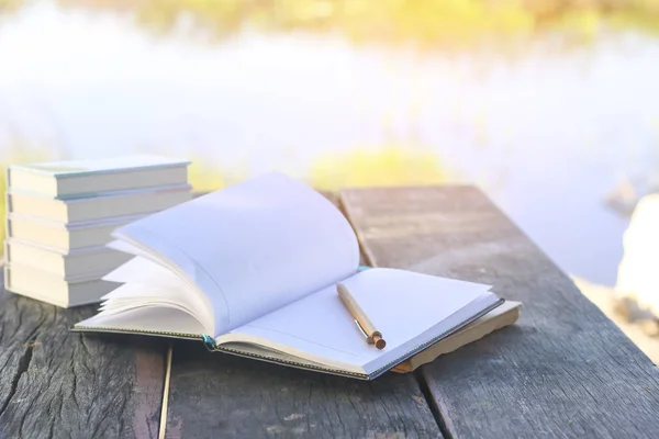 Stock Photo Open book with flipped pages, in the park. Selective focus, green nature background — Stock Photo, Image