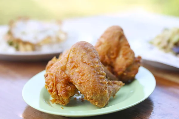 Stock Photo Chicken wings Fried in white dish on wooden table
