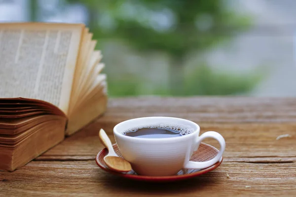 Stock Photo - Coffee cup & book on wood table - vintage (retro) ) — стоковое фото