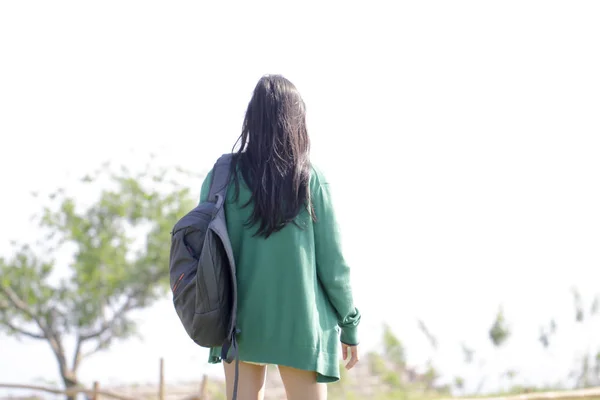 asia woman standing on fell and looking forward,freedom journey