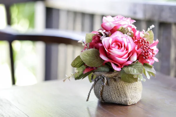 Beautiful rose in vase on table out door — Stock Photo, Image