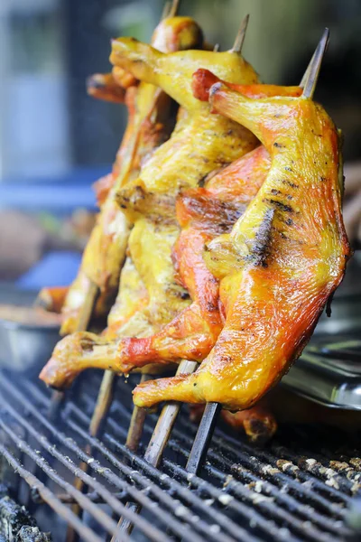 Chicken legs on barbecue grill with fire — Stock Photo, Image