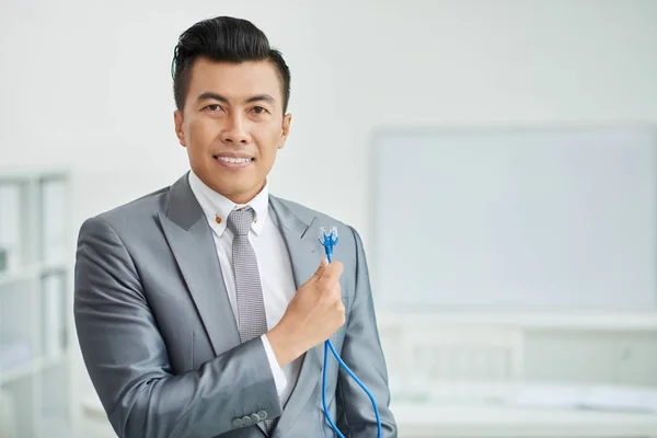 Businessman holding internet cables — Stock Photo, Image