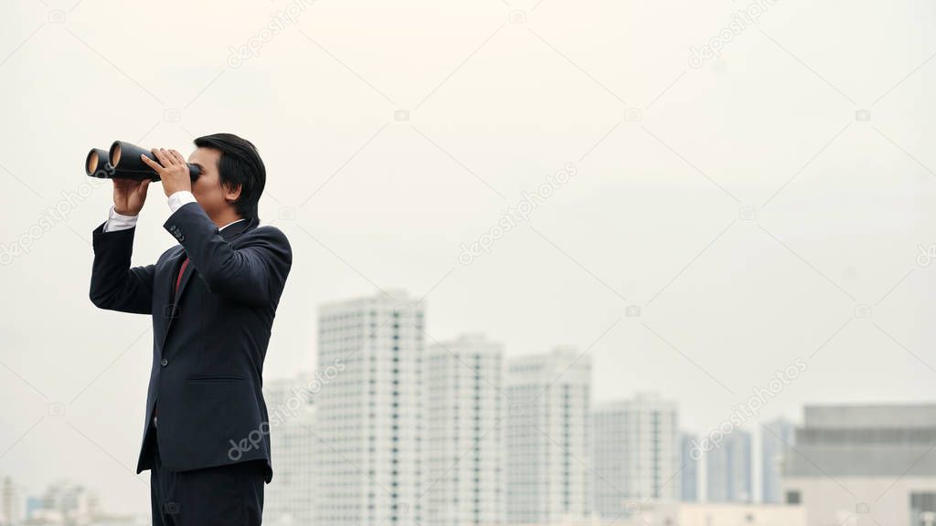 Business executive looking at city