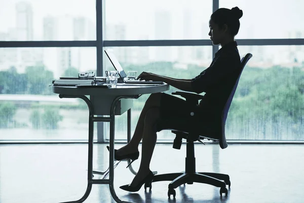 Senhora de negócios trabalhando no laptop à mesa — Fotografia de Stock