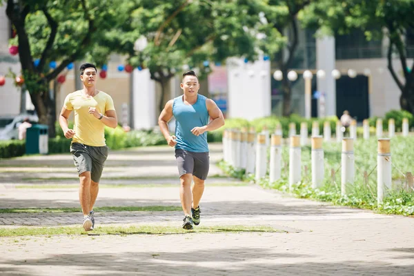 Friends jogging together in street — Stock Photo, Image