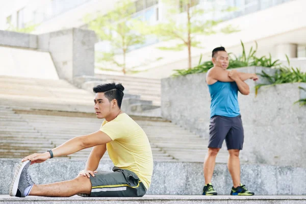 Sporters stretching na het joggen — Stockfoto