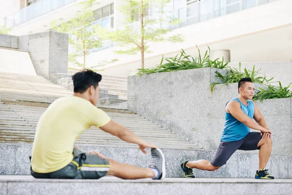 Hombres haciendo ejercicios para las piernas al aire libre — Foto de Stock