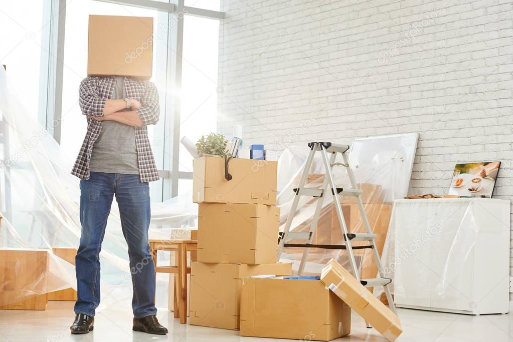 manager standing with cardboard box on head