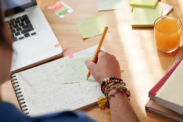 Main de femme écrivant du texte dans un cahier — Photo