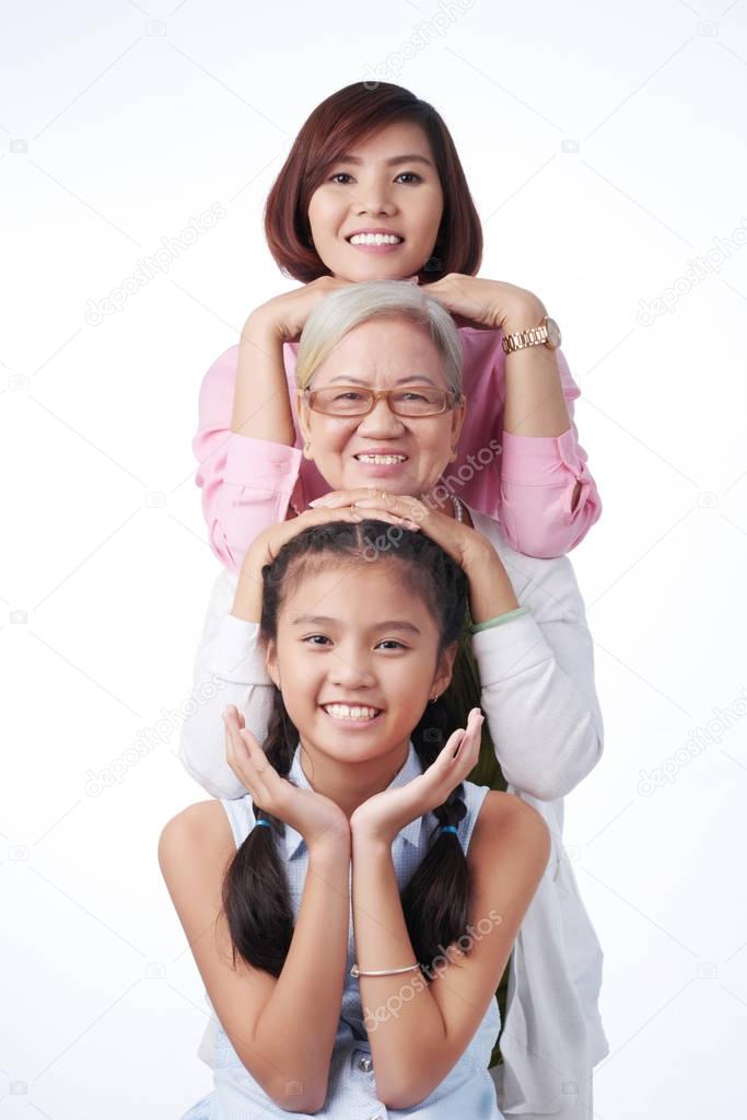 three generation of women smiling at camera