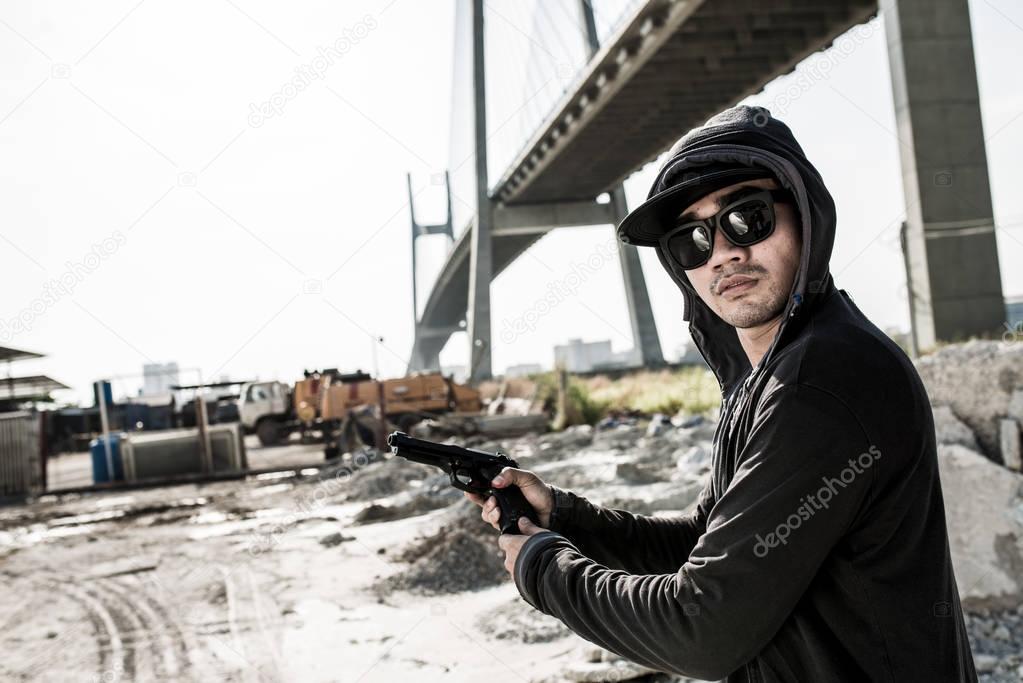 Gangster in hood and sunglasses