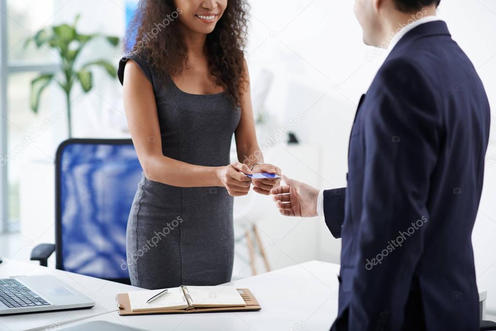 entrepreneur giving business card to client