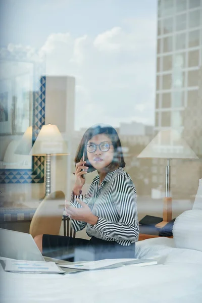 Female entrepreneur sitting on hotel bed