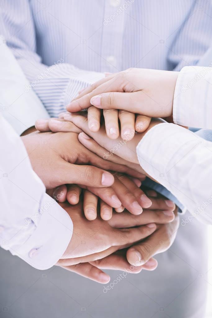 business people stacking hands