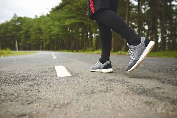 jogger ready to run along road