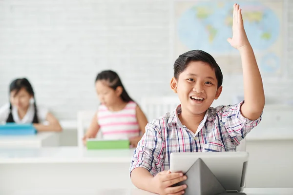 Schoolboy rising hand — Stock Photo, Image