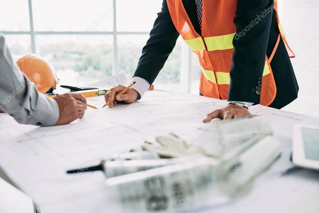 Engineers working on new building blueprint