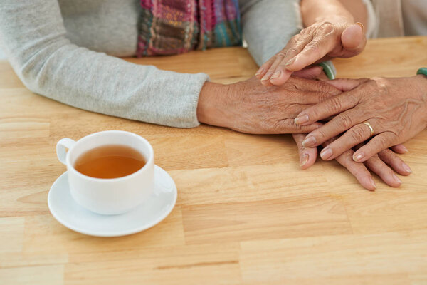 mature woman comforting friend