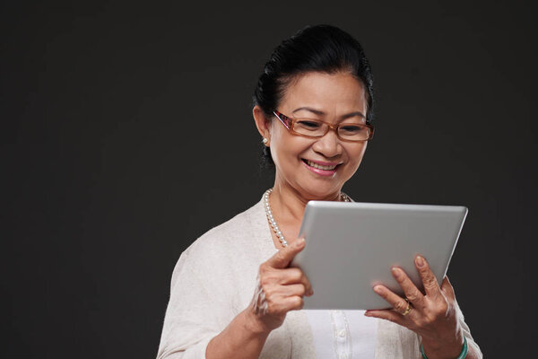 Woman reading something on tablet