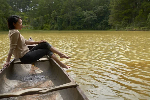 Asian woman sitting in boat