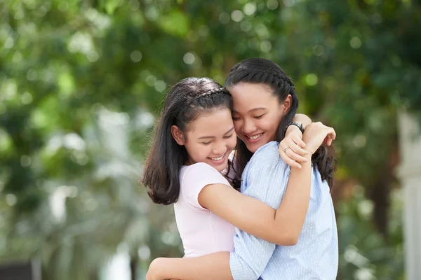 sisters hugging each other